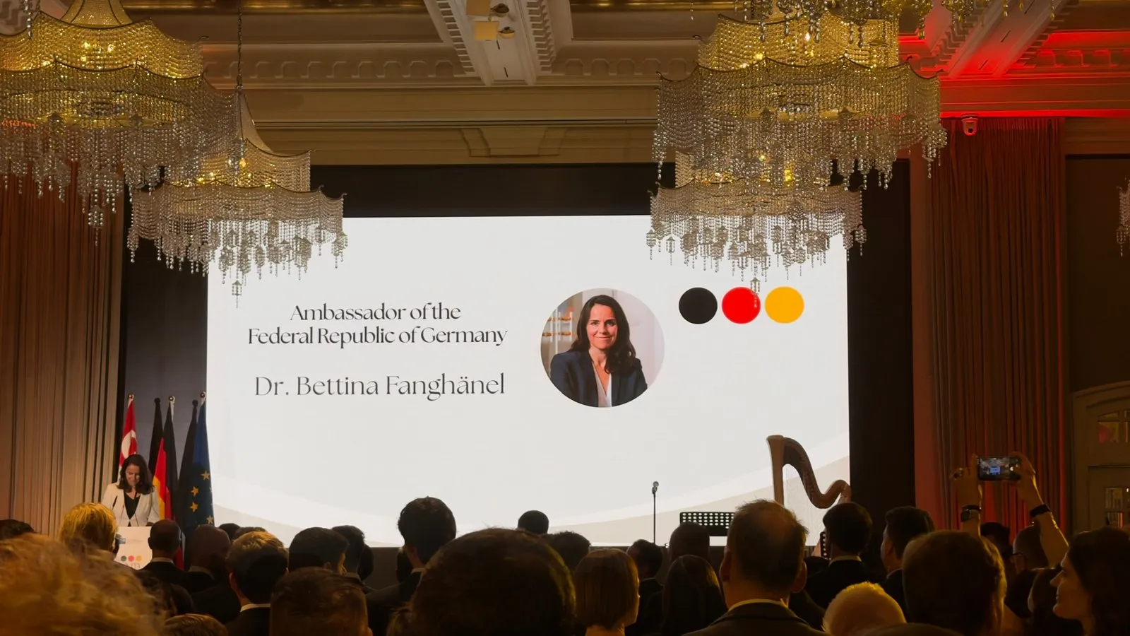 Germany's Ambassador to Singapore, Dr Bettina Fanghänel, at the lectern, with her name on the screen beside the stage